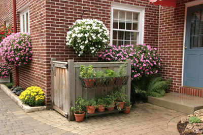 A decorative barrier will both enhance your outdoor space and hide your trash can from sight.
